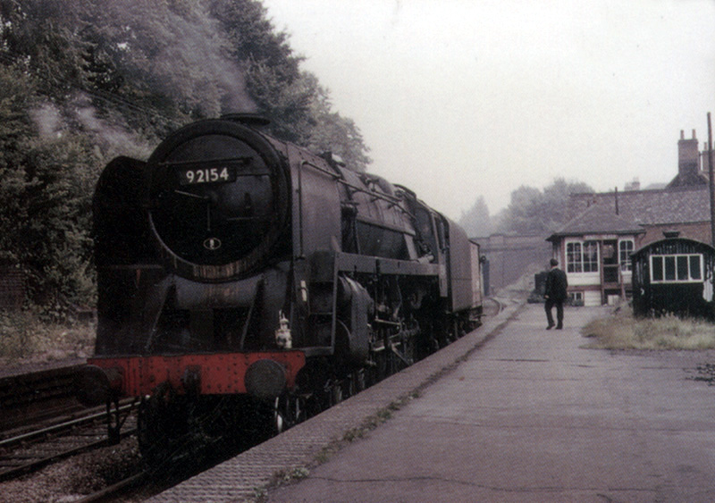 British Railways Standard Class 9F No 92154 passes through Kings Heath with a single guards van in tow