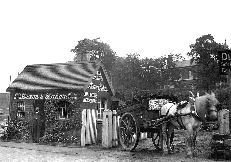 View of Mr Baker standing in the doorway of Dixon & Baker Coal & Coke Merchant's offices in station drive