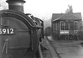 Ex-GWR 4-6-0 Hall class No 5912 'Queen's Hall' passes by Kings Heath signal box on 10th November 1957