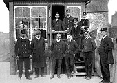 Members of staff from Kings Heath station pose on and in front of the steps to the signal box circa 1920