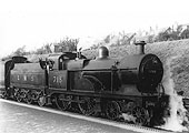 LMS 3P 4-4-0 No 718 stands in the station on a local train
