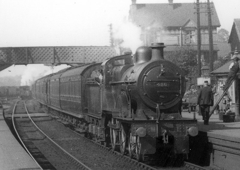 MR 4-4-0 No 426 passes under the passenger footbridge