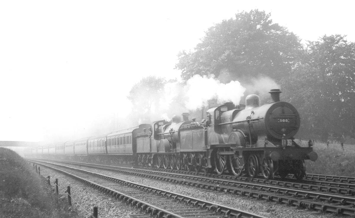 A pair of ex-MR class 2P 4-4-0s No 505 and No 368 are seen running at speed at the head of an express train