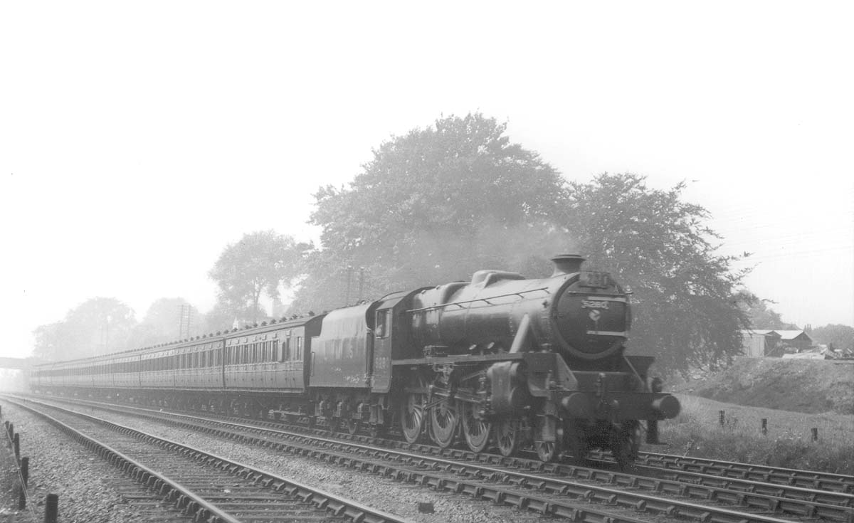 LMS Stanier 5P5F No 5280 is seen sporting train reporting number 230 as it hurries past with a long express train