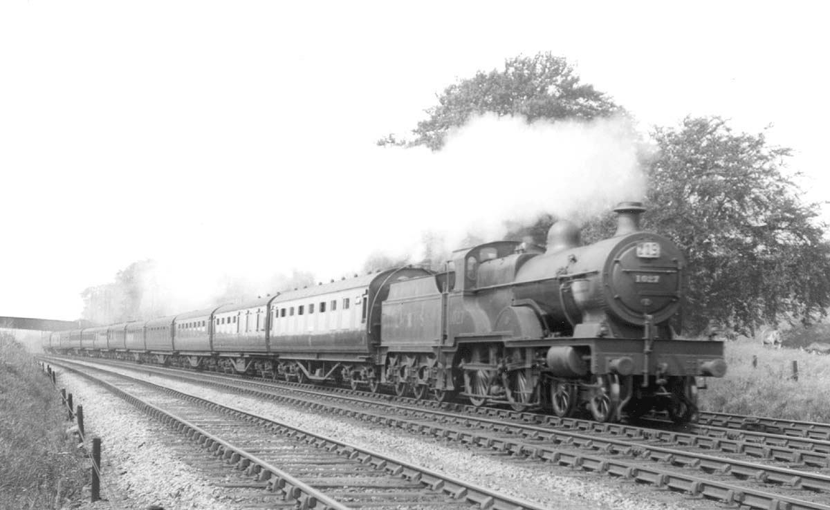 LMS 4-4-0 'Compound' 4P No 1027 is working very hard whilst on a twelve coach express train in the summer of 1936
