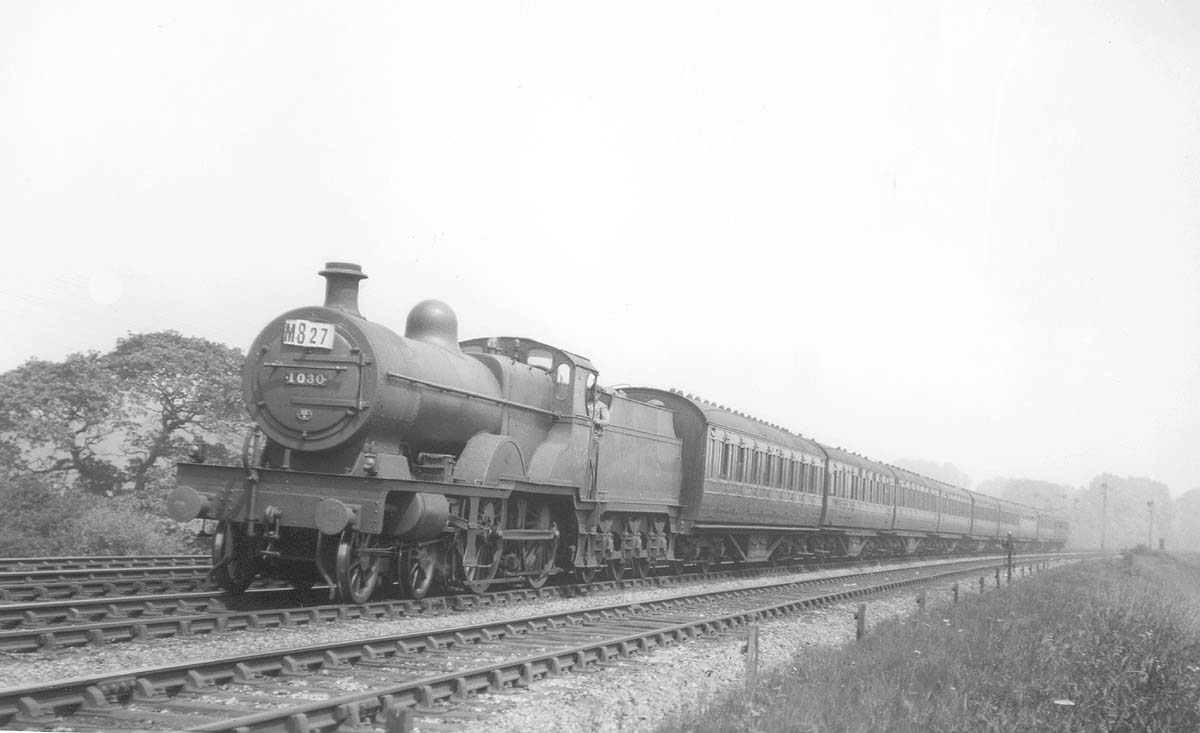 LMS 4-4-0 'Compound' 4P No 1030 is seen at the head of a holiday special express passenger working during the summer of 1937