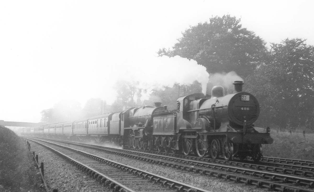 Ex-MR 4-4-0 2P No 406 is seen piloting LMS 4-6-0 Jubilee class No 5638 'Zanzibar' on a 12 coach train