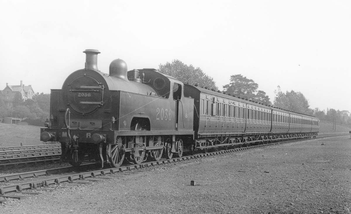 MR 0-6-4T 'Flatiron' No 2036 is seen heading a local passenger train of close coupled carriages circa 1921