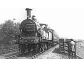 MR 2-4-0 No 198 heads a local train past Kings Norton station's carriage storage and goods sidings