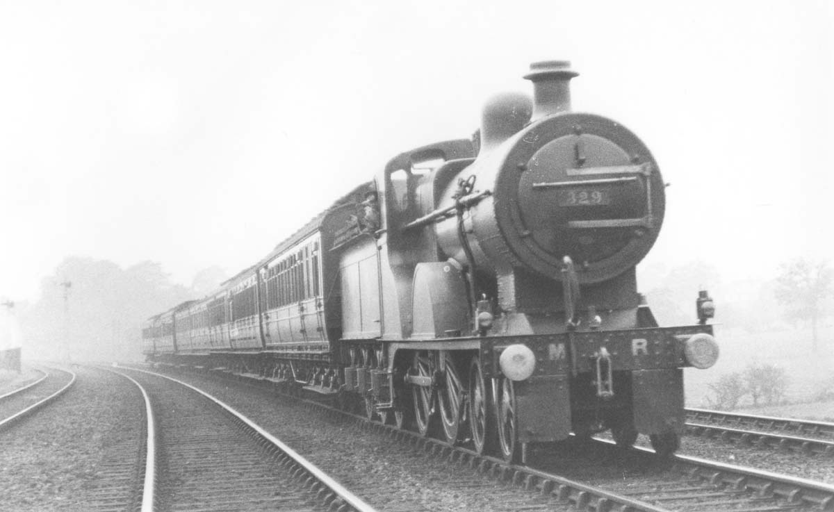 MR 4-4-0 No 329 passes at speed on an up express passenger train south of Kings Norton