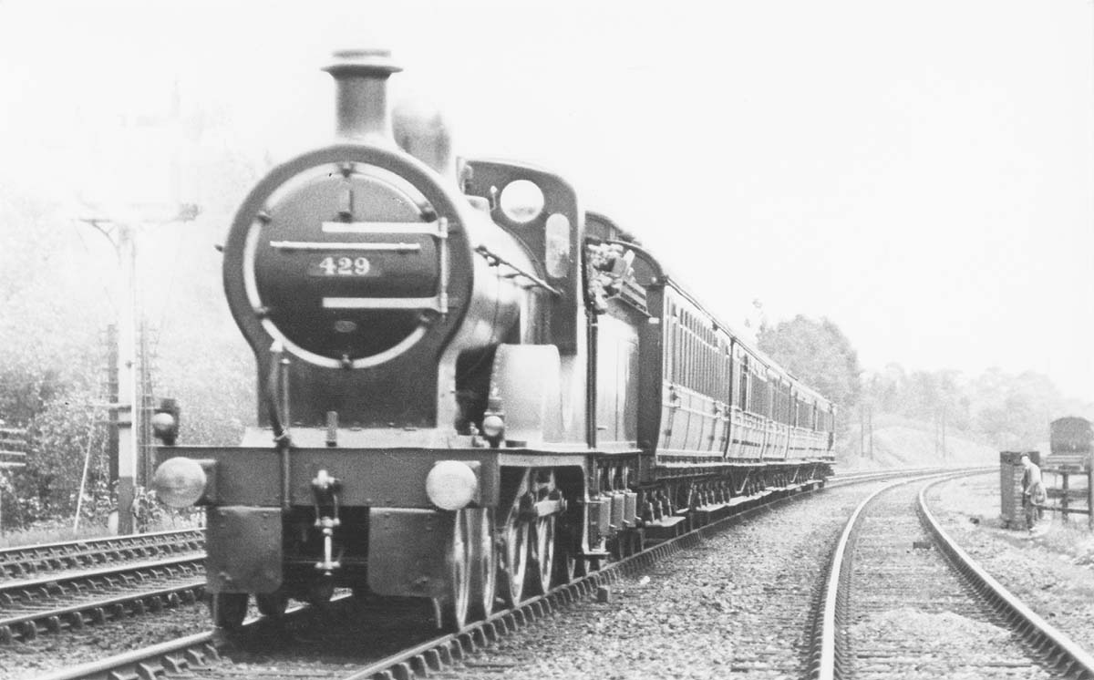 MR 4-4-0 No 429 heads a down express passenger service just south of Kings Norton station