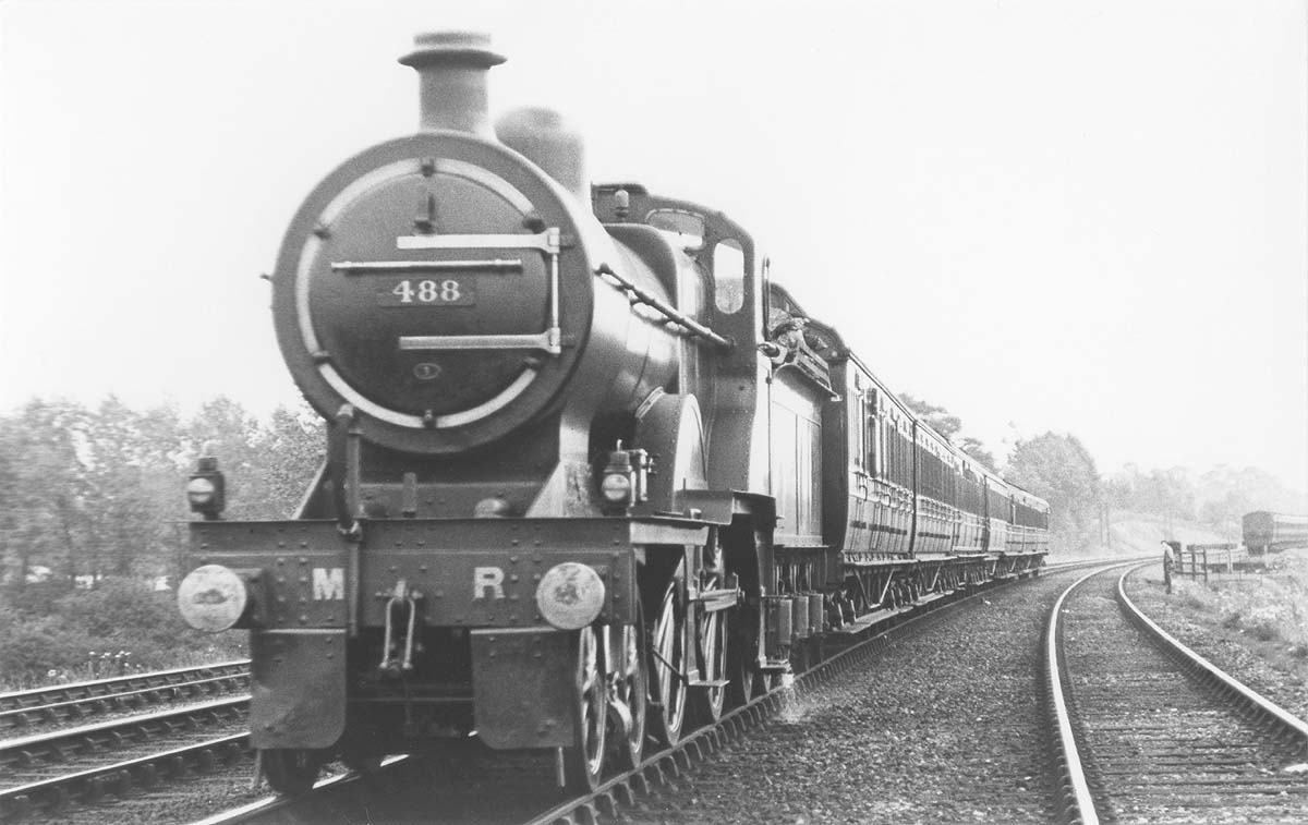 MR 4-4-0 No 488 is seen on a down express passenger service having just passed the carriage sidings on 16th July 1921