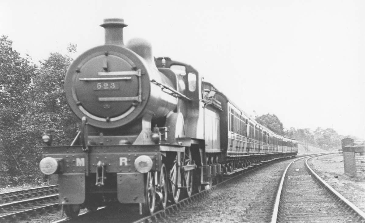 MR 4-4-0 No 523 is seen carrying its No 3 Saltley shed plate whilst on a down express train on 16th July 1921