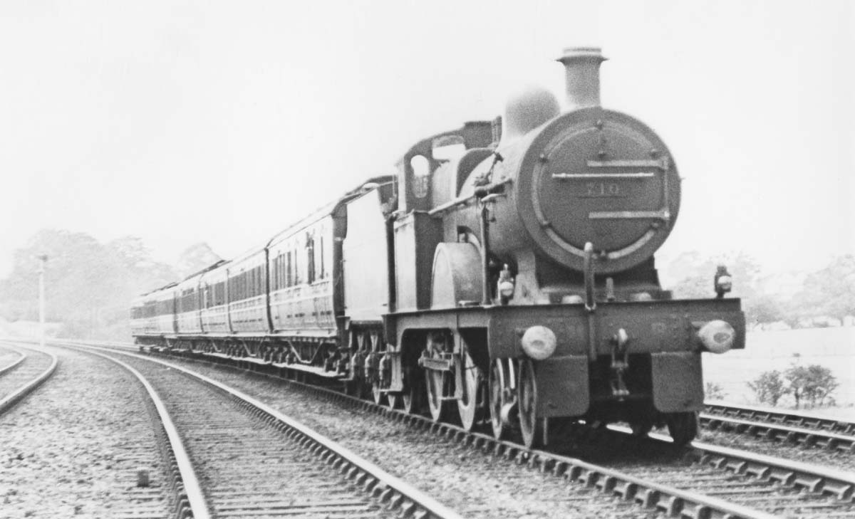 MR 4-4-0 3P No 710 is at the head of an express service as it passes the Permanent Way gang's lineside hut on 16th July 1921