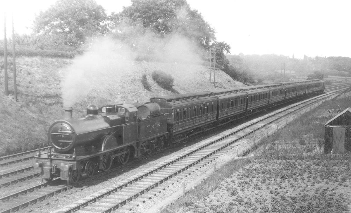MR 4-4-0 3P No 773 with oil tanks fitted to its tender is seen working hard at the head of a train of clerestory coaches in 1921