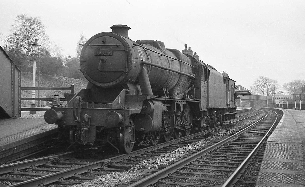 Ex-LMS 8F 2-8-0 No 48449 is passing through Kings Norton Station towing a brake van en-route to pick up a goods train