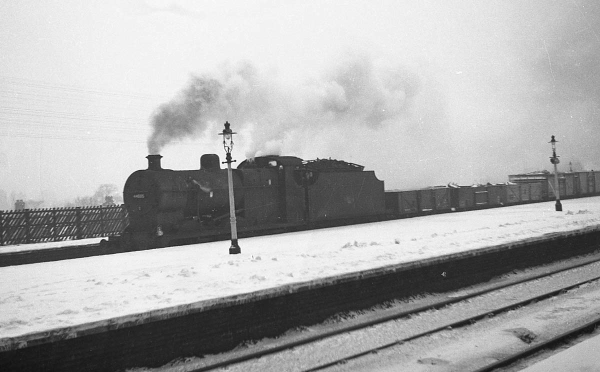 Ex-LMS 0-6-0 4F No 44605 is passing Kings Norton Station with a mineral train for Washwood Heath on a snowy winter's day