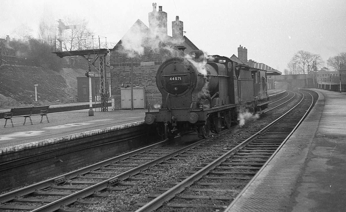 Ex-LMS 4F 0-6-0 No 44571 runs through Kings Norton Station with a Brake Van in tow on the way to the goods yard to pick up a goods working