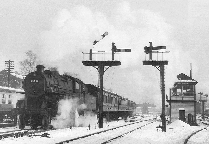 British Railways built Ivatt 2-6-0 4MT No 43047 is seen passing Kings Norton signal box on 10th January 1959