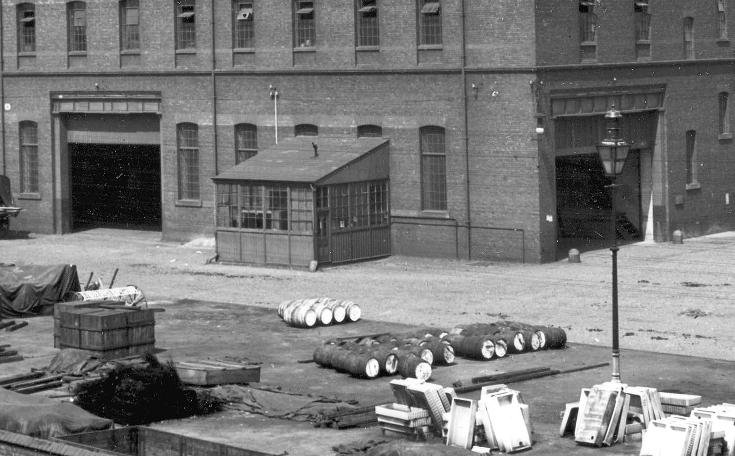 Close up showing the corner of Lawley Street Goods & Grain Warehouse, an external checker's office and the inside of the road entrance
