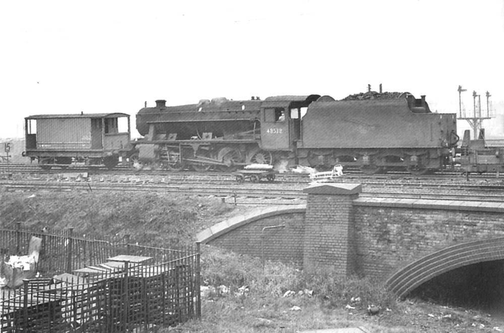 Ex-LMS 2-8-0 8F No 48538 is coupled to goods brake van D1659 allocated for departmental use on 21st November 1964