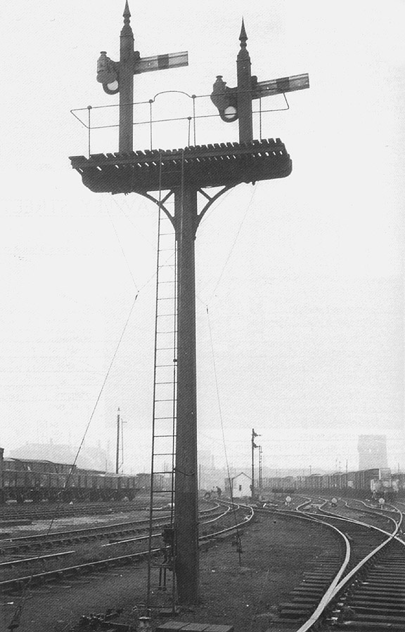 Looking north showing the rear of the bracket signal carrying signals No 21 and No 20 with in the distance Saltley shed on the right and the gasworks on the left