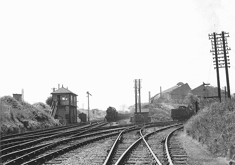 An unidentified ex-LMS 0-6-0 4F locomotive passes Lifford Station Junction signal box with an up goods train during the 1950s