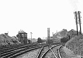 An unidentified ex-LMS 0-6-0 4F locomotive passes Lifford Station Junction signal box with an up goods train