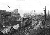An unidentified ex-MR 0-6-0 3F locomotive is seen running tender first at the head of a goods train on 3rd May 1953