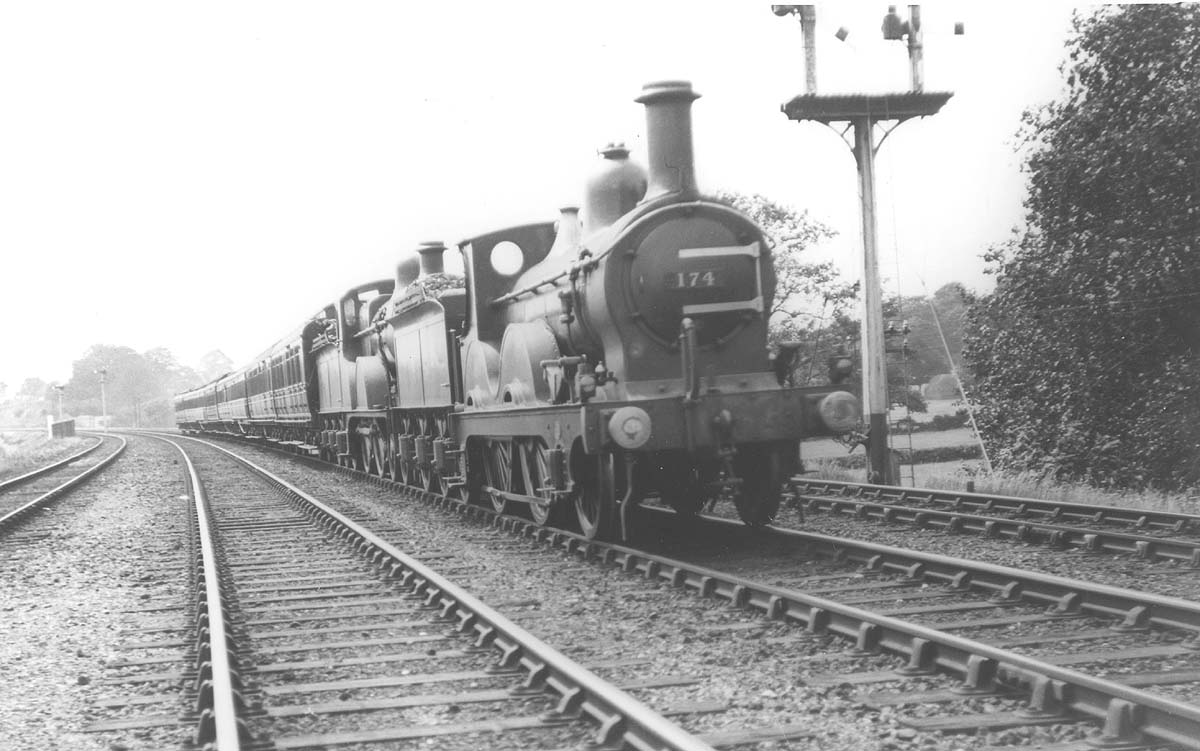Midland Railway 2-4-0 1P No 174 is seen piloting Midland Railway 4-4-0 2P No 368 on a passenger train on 16th July 1921