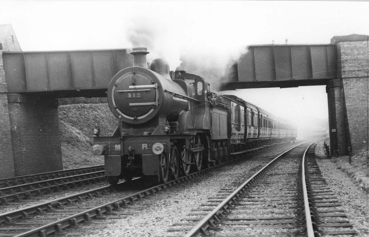 MR 4-4-0 2P No 512 with steam blowing off from its safety valves passes at speed near Northfield