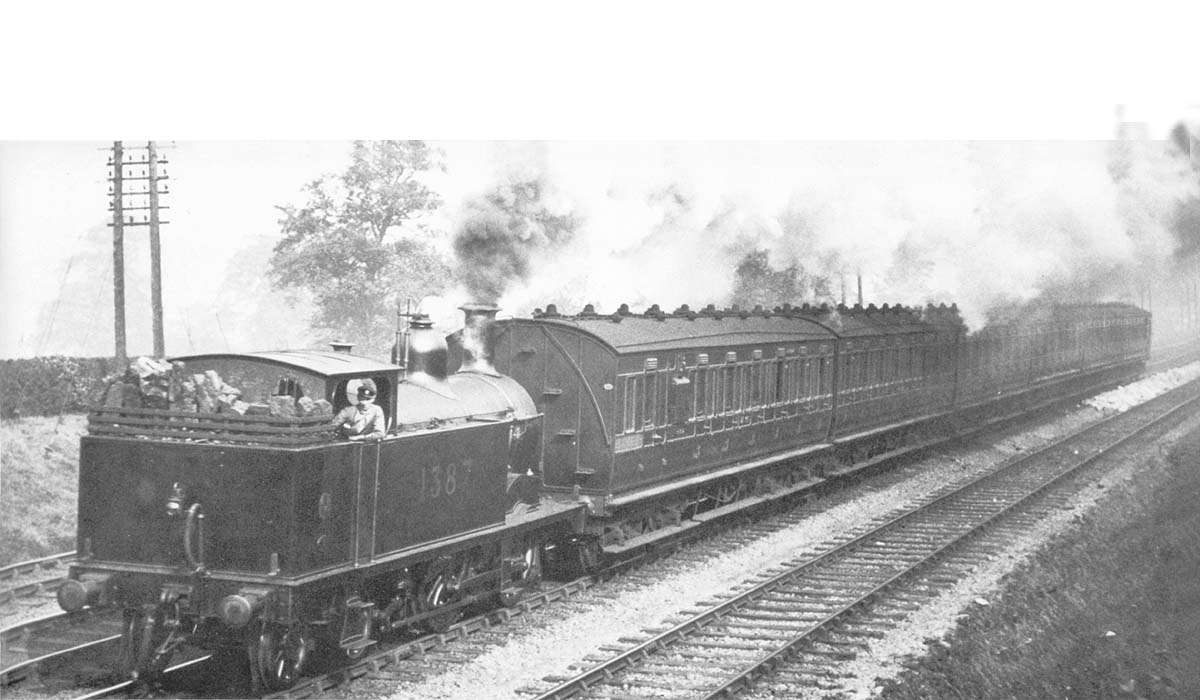 MR 1P 0-4-4T No 1387, running bunker first, works a down local passenger comprised of close-coupled ex-MR stock