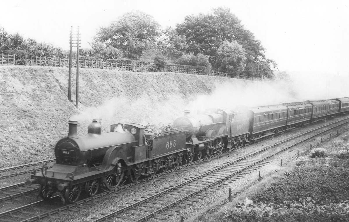 MR 'Spinner' 4-2-2 1P No 683 is seen piloting LMS 'Compound' 4-4-0 No 1090 on an express passenger service near Northfield during August 1925
