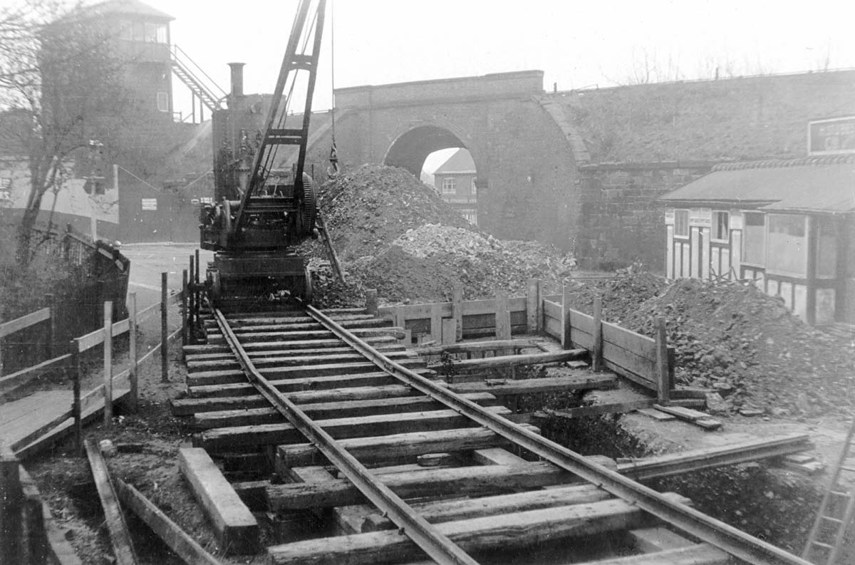View of the steam powered mobile crane mounted on temporary track undertaking engineering work at Mill Lane