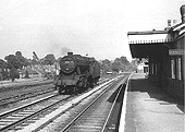Ex-LMS 2-8-0 8F No 48121 is seen running tender first on the up goods line as it passes Northfield's goods yard