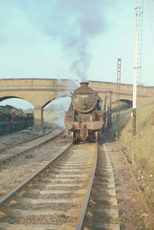 Ex-LMS 5MT 4-6-0 No 45057 heads off the Ashby line at Midland Junction with Stoney Road bridge in the background
