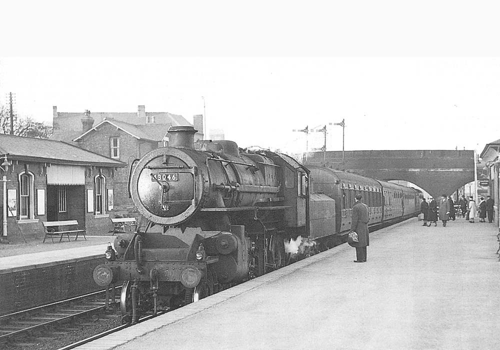 British Railways built 'Ivatt' 4MT 2-6-0 No 43046 arrives at Nuneaton Abbey Street on 12th April 1958 with the 2:26pm Ely to Birmingham service