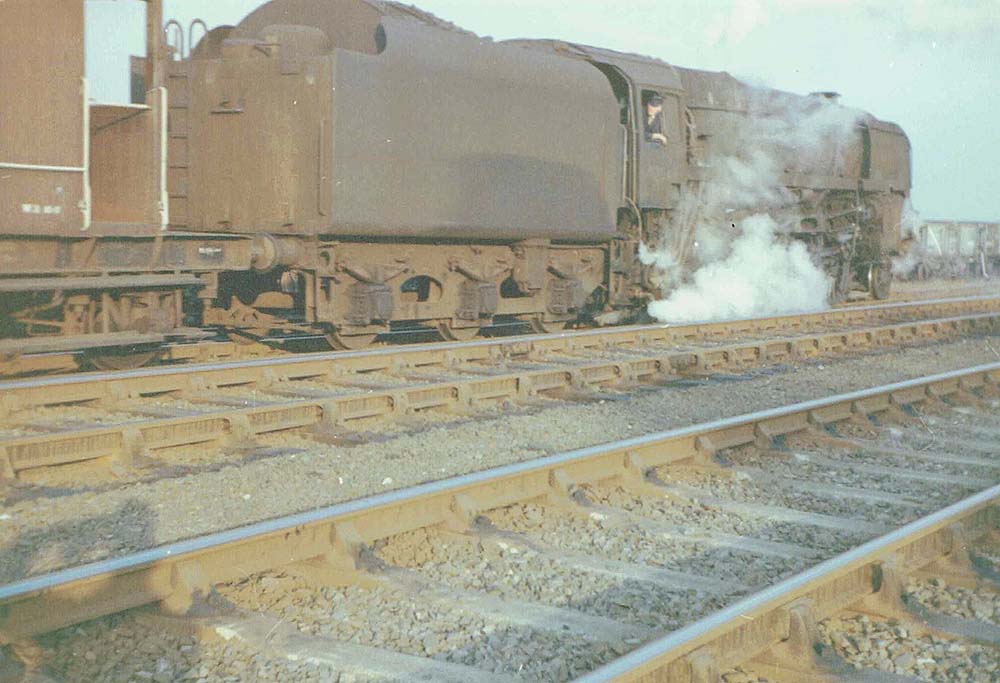 An unidentified British Railways Standard Class 9F 2-10-0 locomotive stands in one of the marshalling sidings at Abbey Street