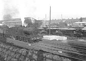 An unidentified ex-LMS 4F 0-6-0 locomotive heads a Class J mineral train past Abbey Street goods yard in the 1960s