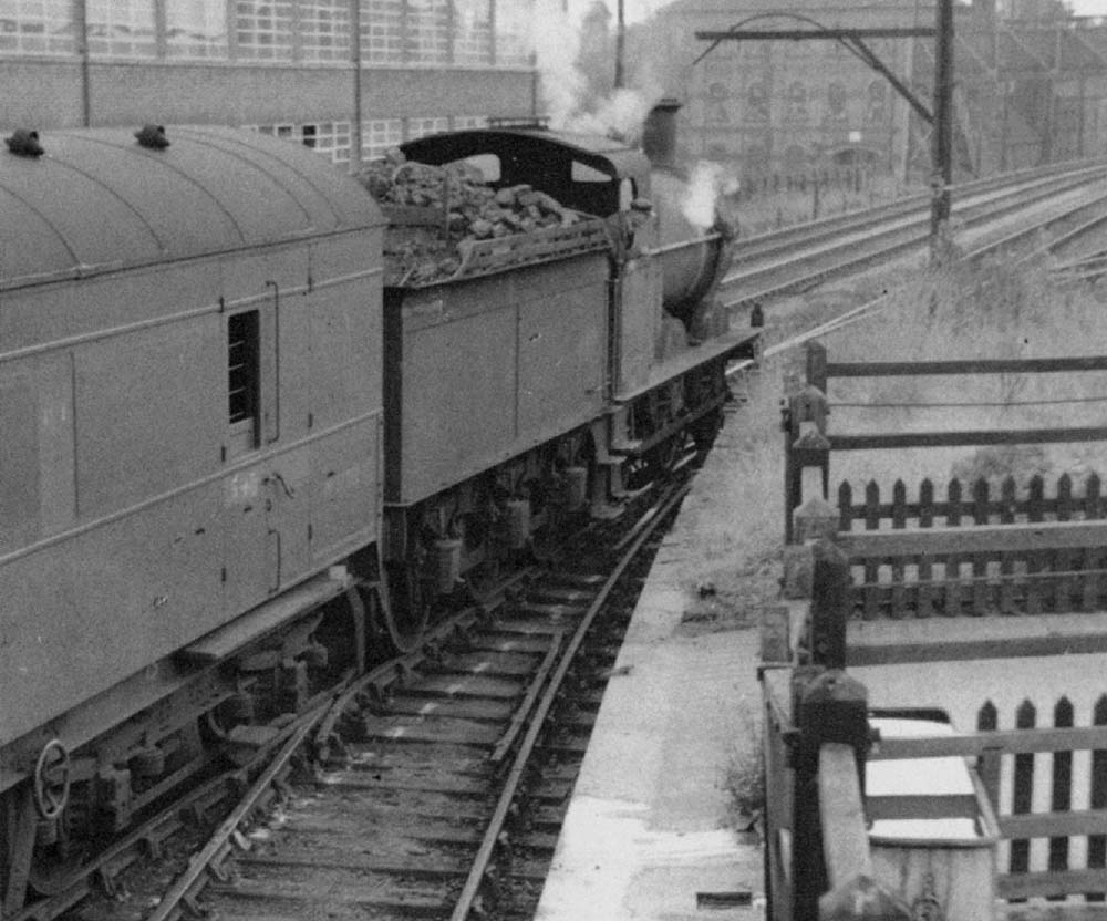 An unidentified ex-MR 3F 0-6-0 locomotive is seen shunting coaching stock adjacent to Redditch cattle pens circa 1955
