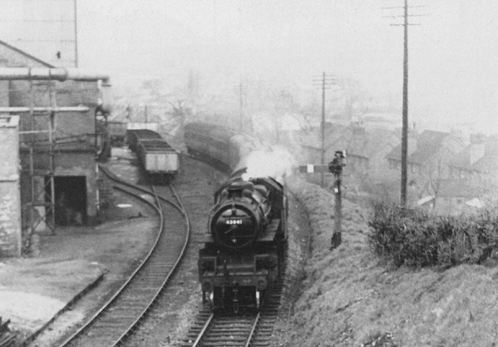 British Railways built 4MT 2-6-0 No 43041 approaches Redditch with an ordinary passenger service circa 1961
