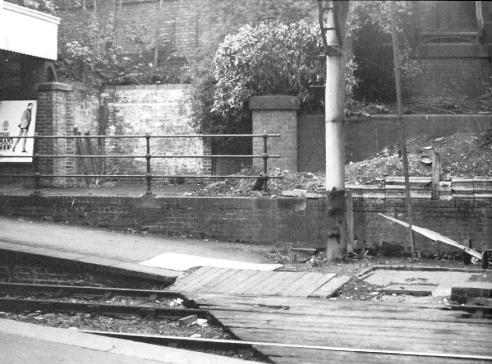 View of the northern end of the up platform showing the barrow crossing and excavated spoil on the path to the footbridge
