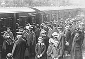 A train of army personnel wait to depart from Redditch station in 1914 as their family and friends look on