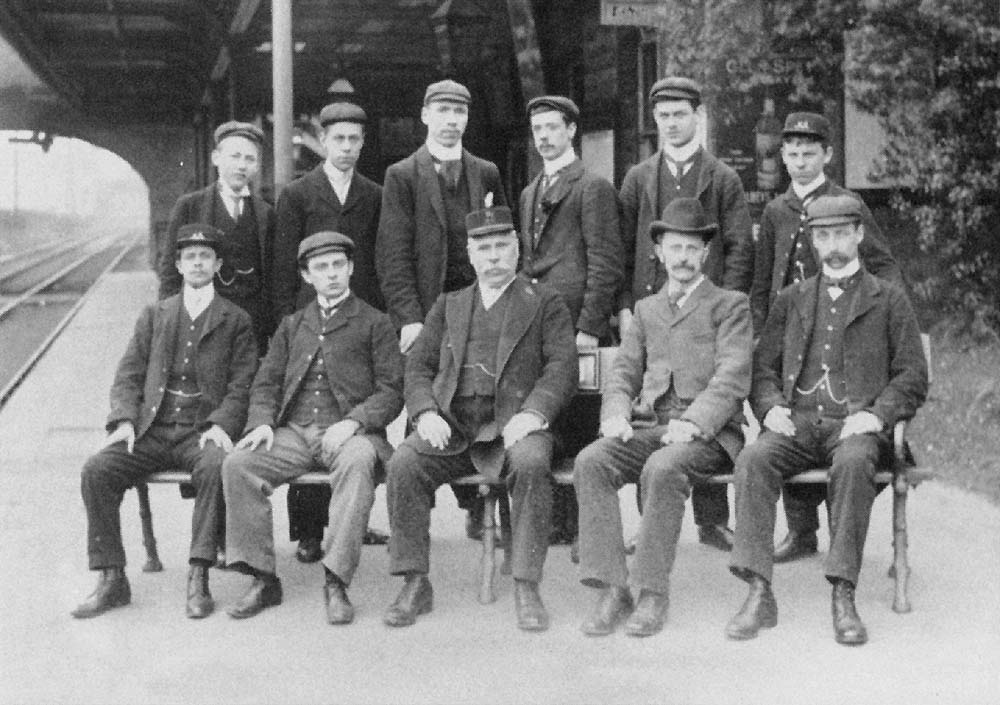 An Edwardian photograph of Redditch station's staff with the Station Master seated in the centre