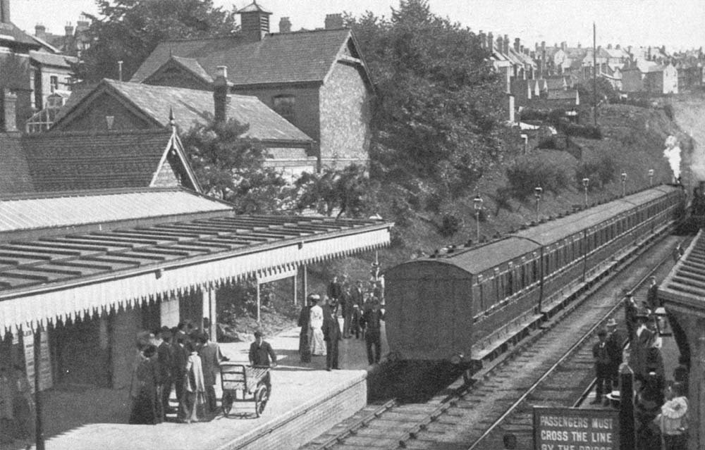 View of the station looking south as a train with a rake of close coupled stock, leaves the station for Evesham