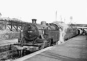 Ex-LMS Fowler 2-6-4T No 42383 stands at the station on a local passenger train on a local passenger service to Ashchurch