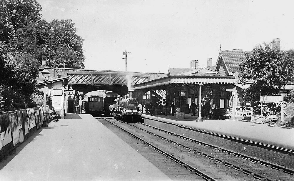 Looking north towards Barnt Green as two goods trains pass each beneath Bromsgrove Road bridge