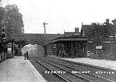 Looking towards Birmingham with a goods locomotive standing in the distance in the goods yard