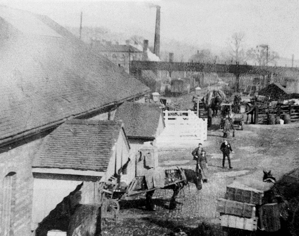 Scene showing the loading of horse drawn vehicles at the MR built goods shed located in Redditch's first goods yard