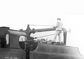 Close up of No 715's fireman topping up the locomotive's tender after trimming the coal as part of preparing the locomotive to go off shed